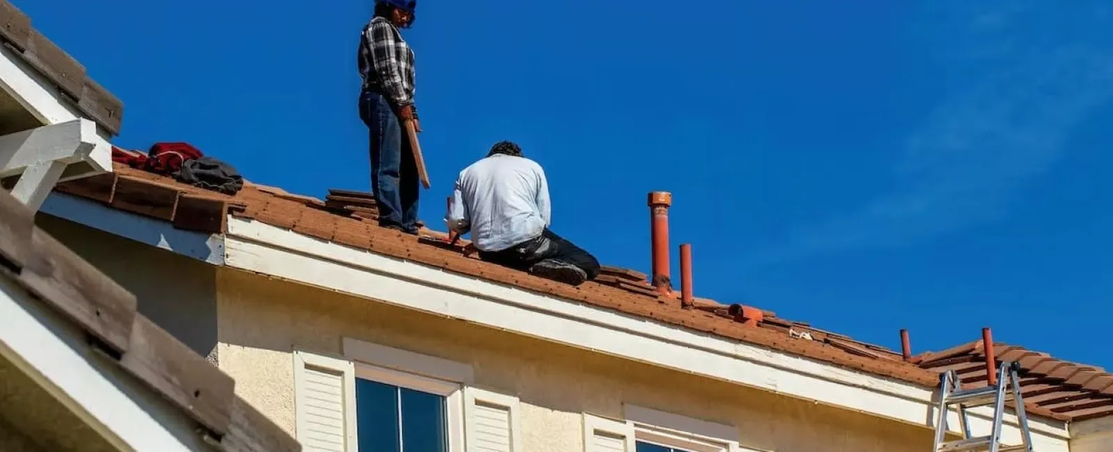 men on top of a roof