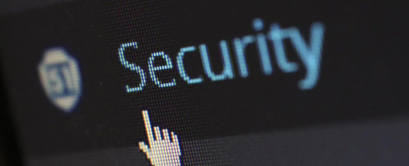 Cursor pointing at the word Security on a digital screen with a shield icon, emphasizing online protection