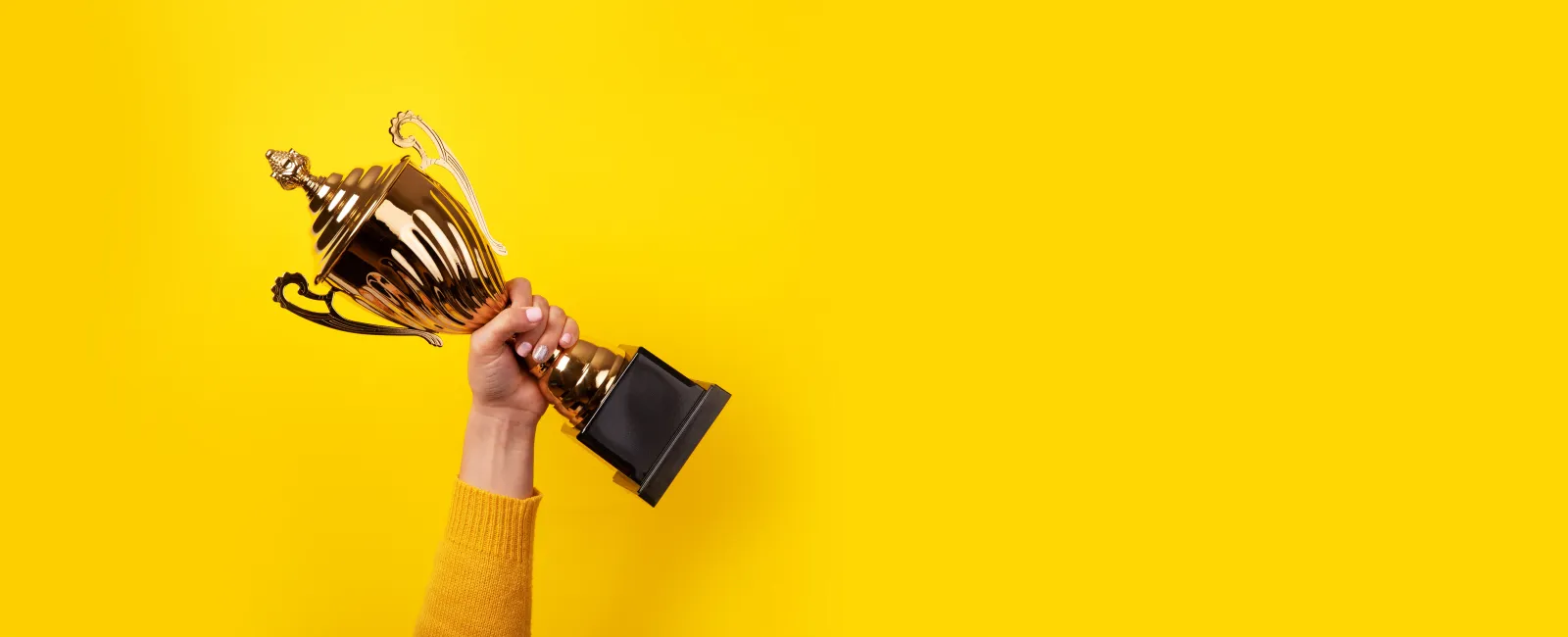 a hand holding a saxophone