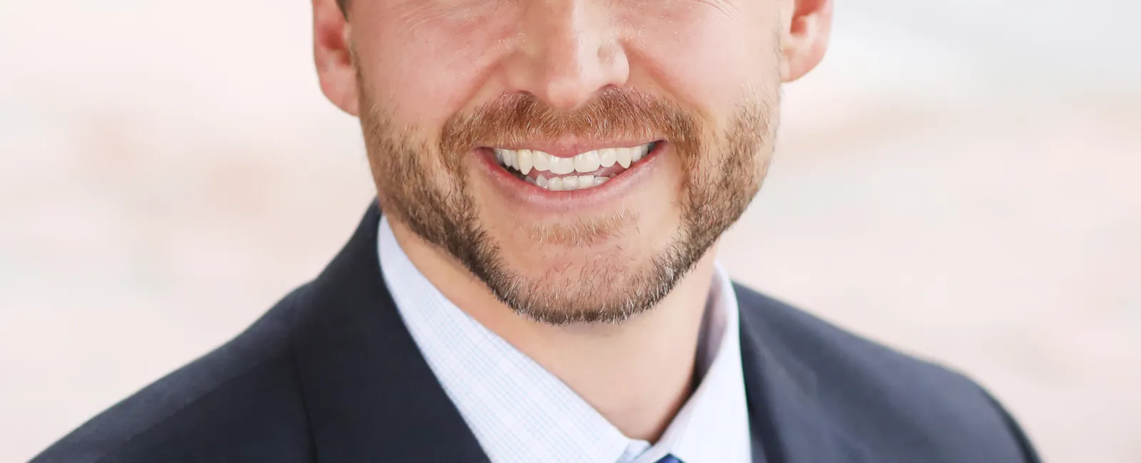 a man in a suit smiling