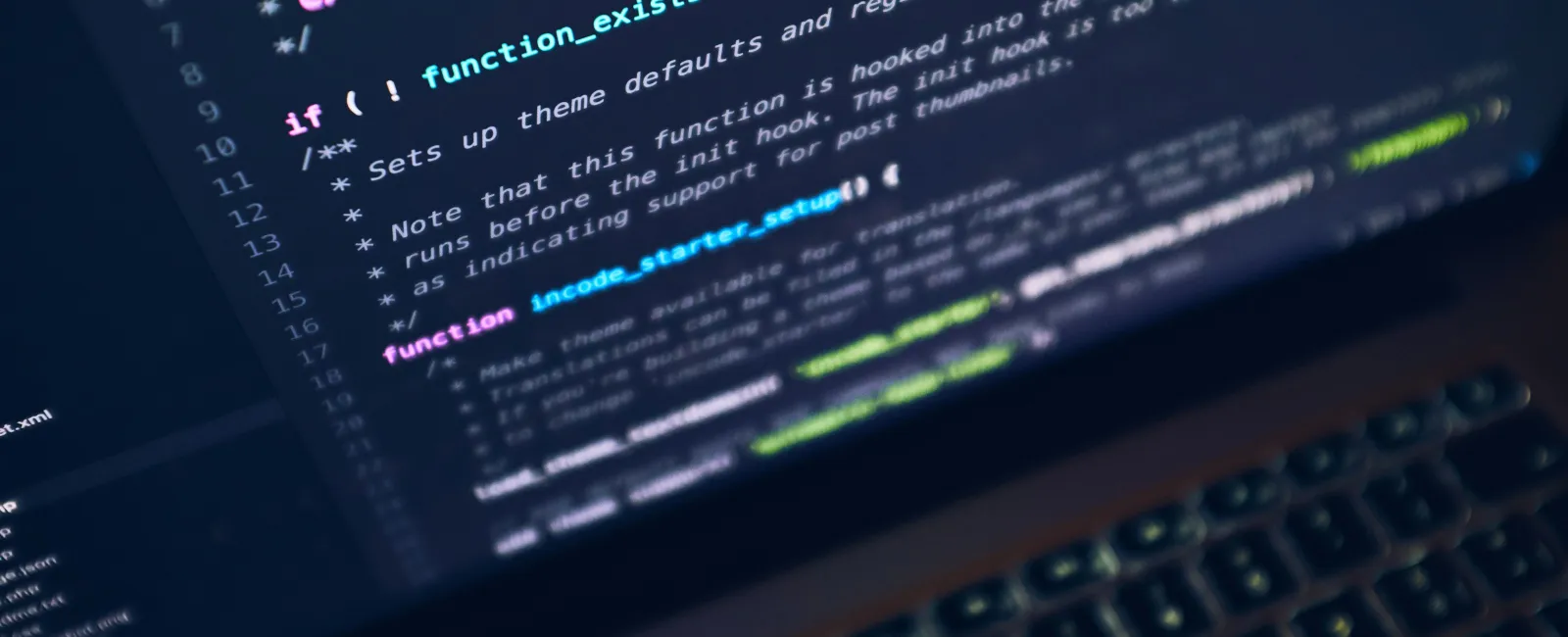 Close-up of a laptop screen displaying colorful programming code with function setup and package references.