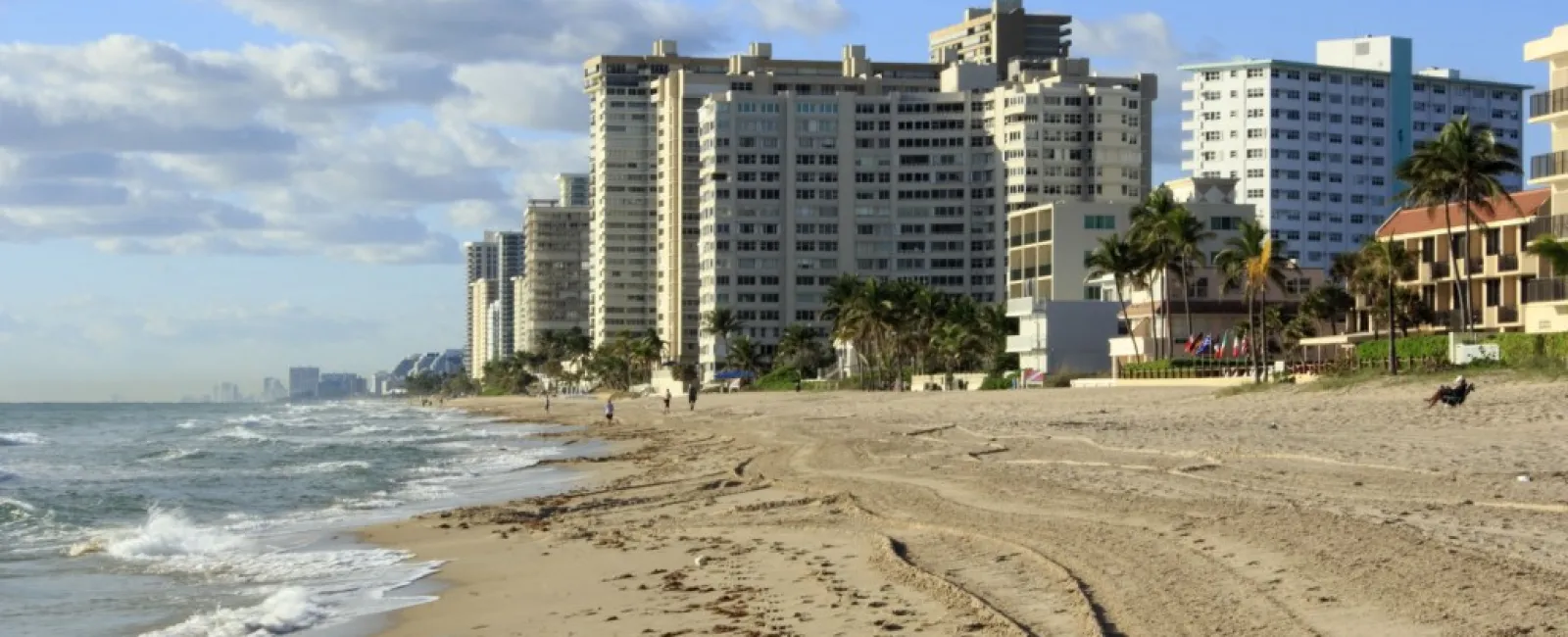 a beach with buildings along it