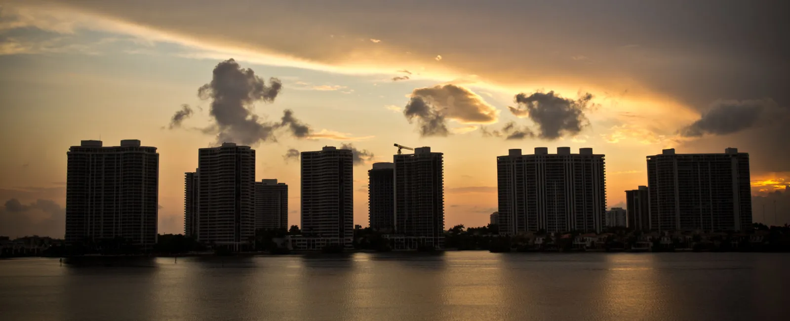 a city skyline with clouds in the sky