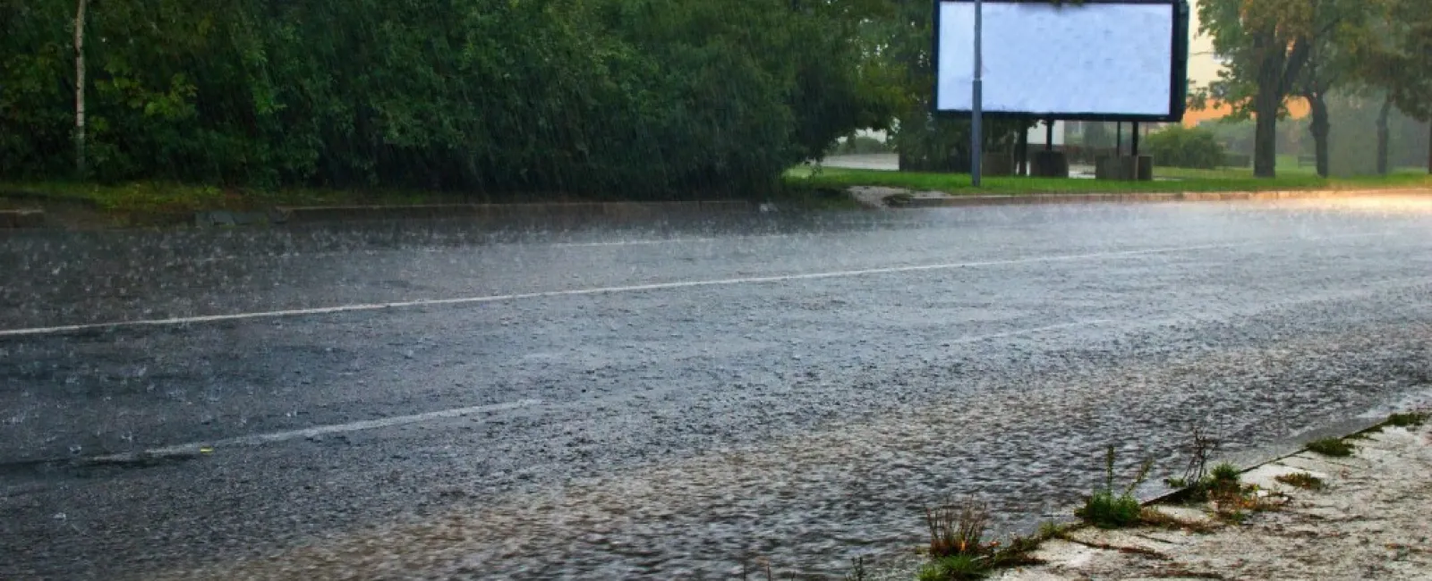 a flooded area with a billboard