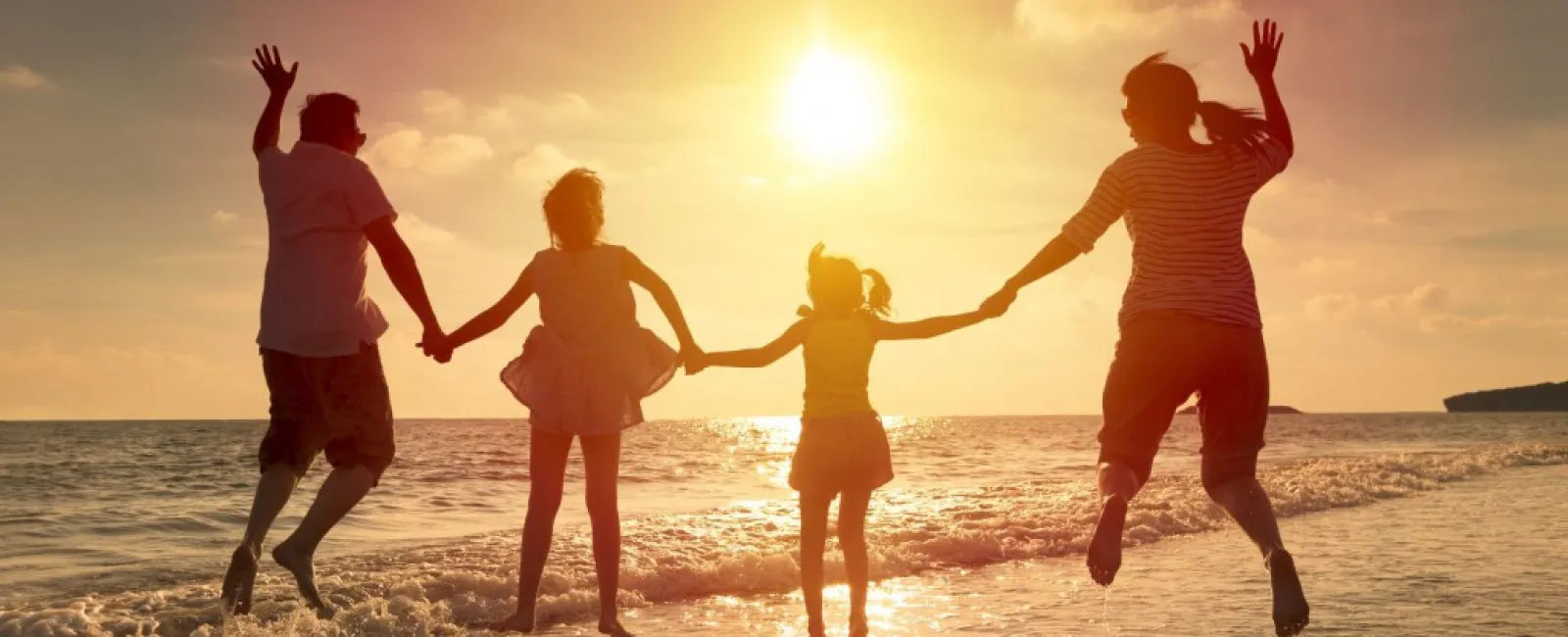 a family running on the beach