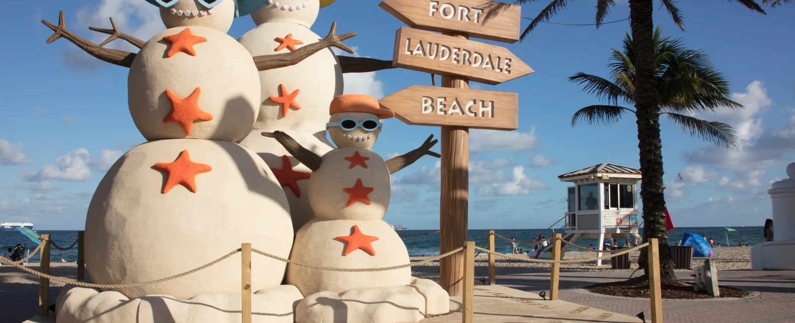 a couple of snowmen on a beach