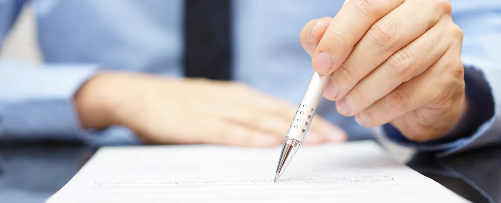 a person writing on a piece of paper