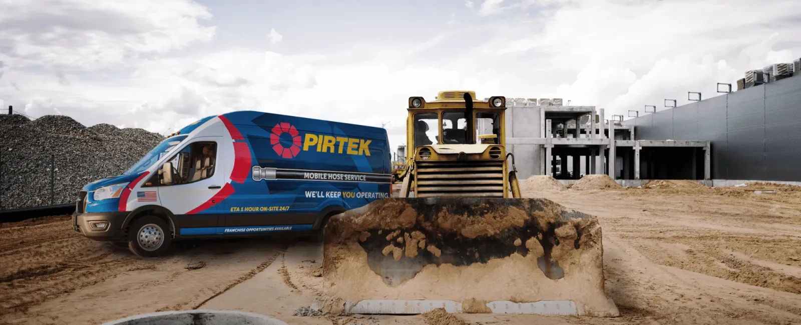 Pirtek service van and bulldozer at a construction site with dirt and concrete structure under cloudy sky