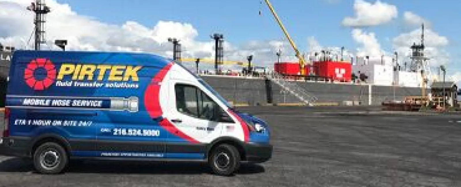 Blue and white PIRTEK mobile hose service van parked near industrial port with ship and crane in the background