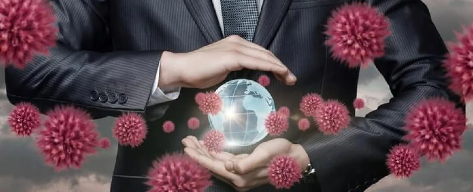 Businessman holding a glowing globe surrounded by 3D red virus particles representing global pandemic impact.