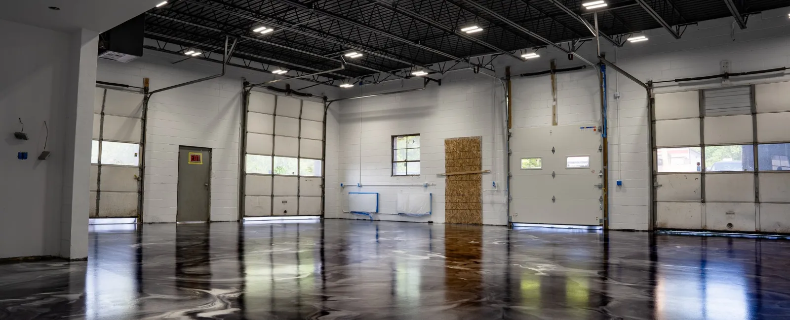 a large empty room with a large glass floor and a large white wall