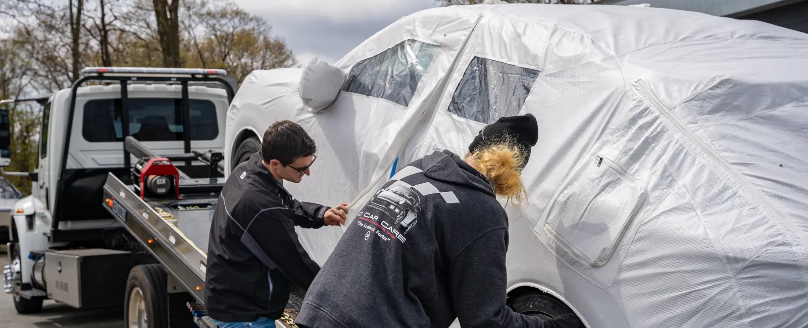 a couple of people looking at a tent