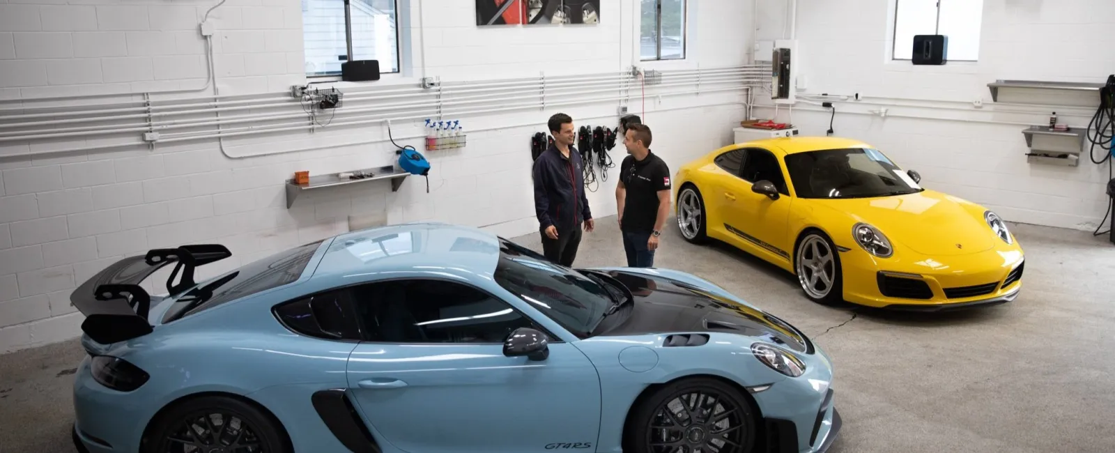 a couple of cars parked in a garage