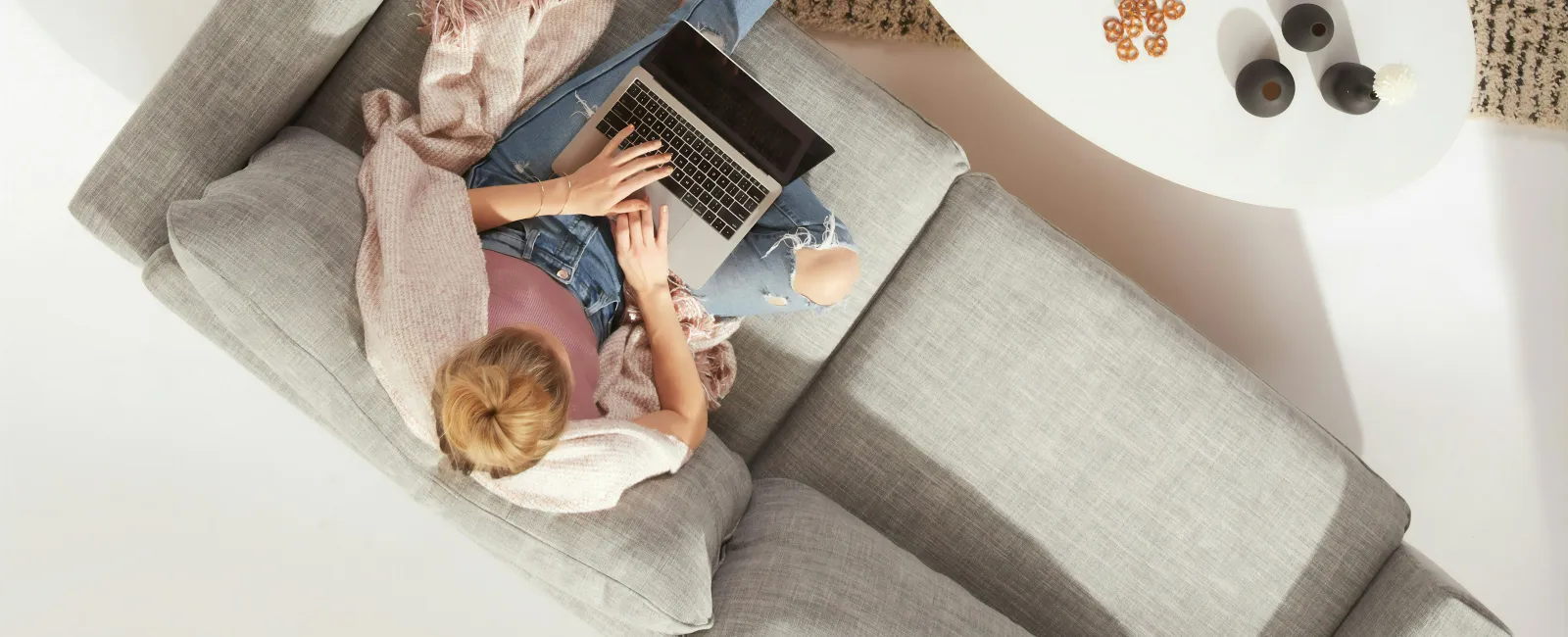 a person lying on a bed with a laptop