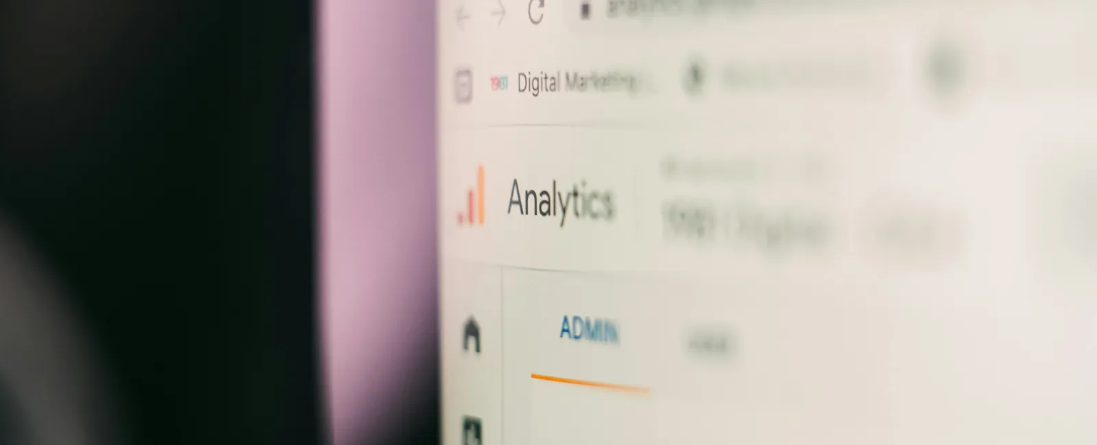 Close-up of a computer screen displaying a digital marketing analytics dashboard with admin menu and data metrics.