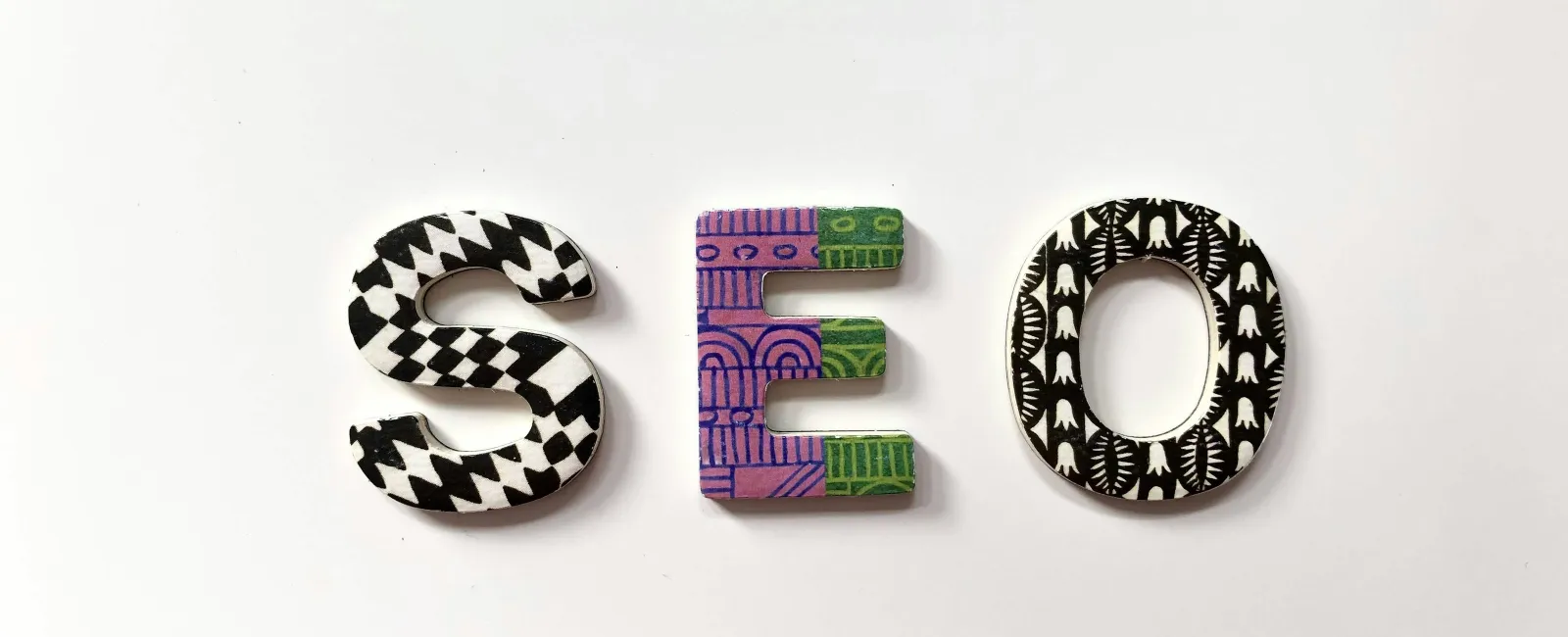 Colorful letters spelling SEO in various patterns on a white background.