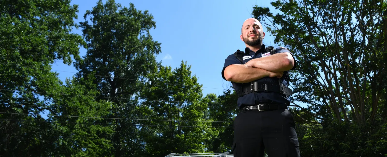 an air conditioning repair technician standing in front of a service van