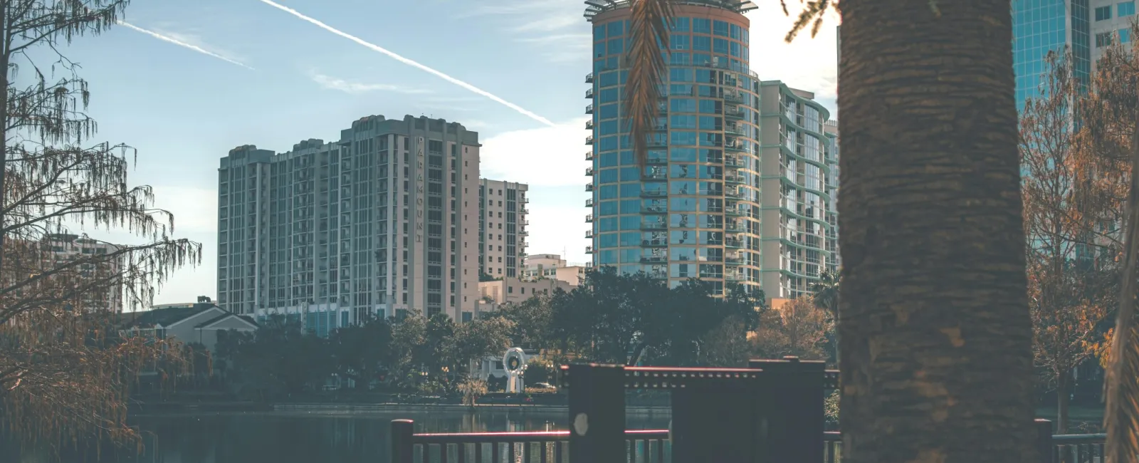 a body of water with trees and buildings around it