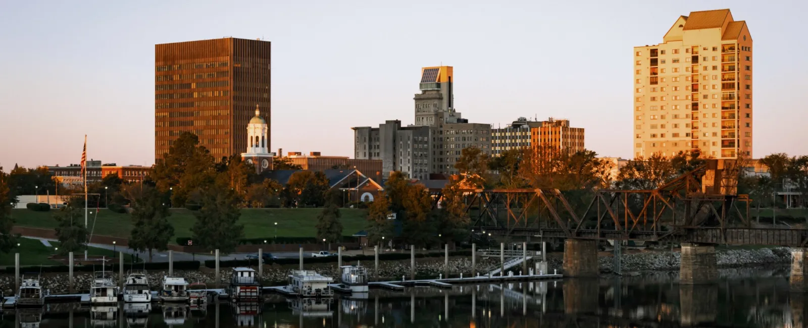 a body of water with boats in it and buildings in the back