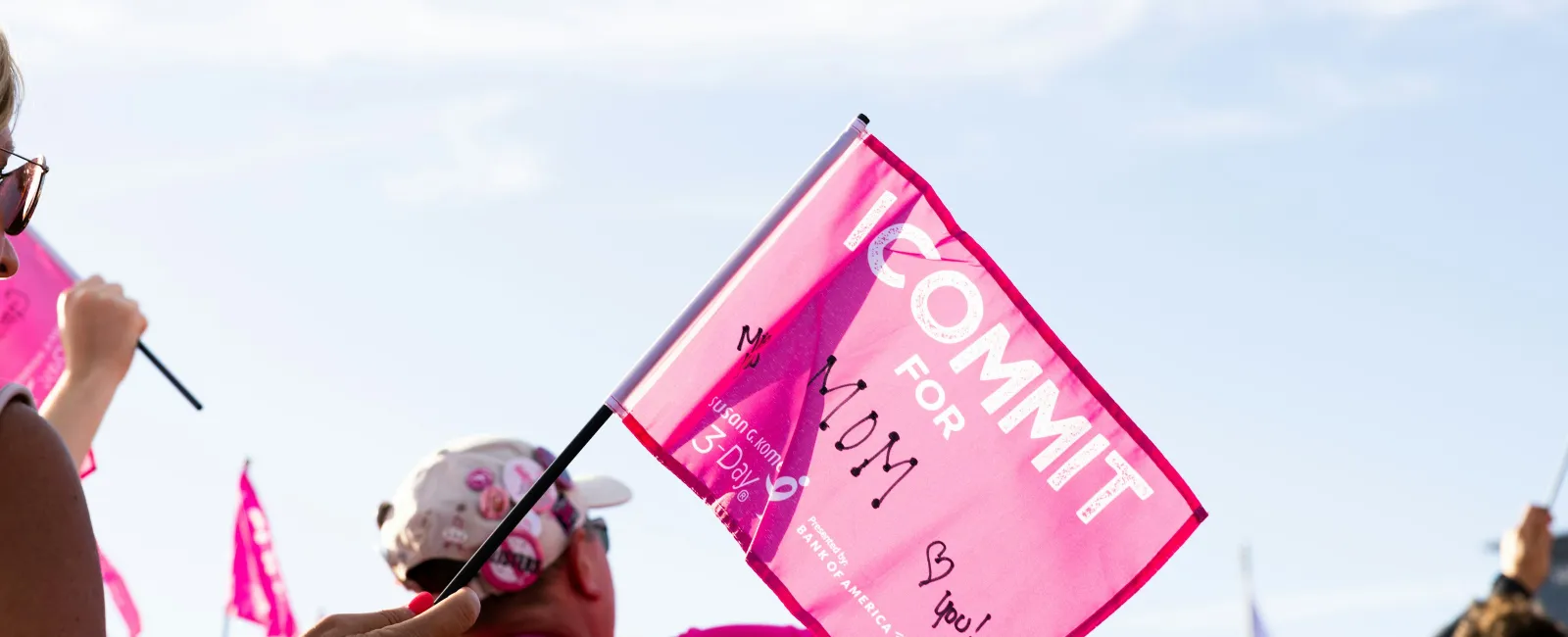 a person holding a pink sign