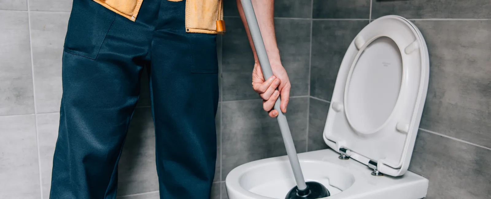 a person cleaning a toilet