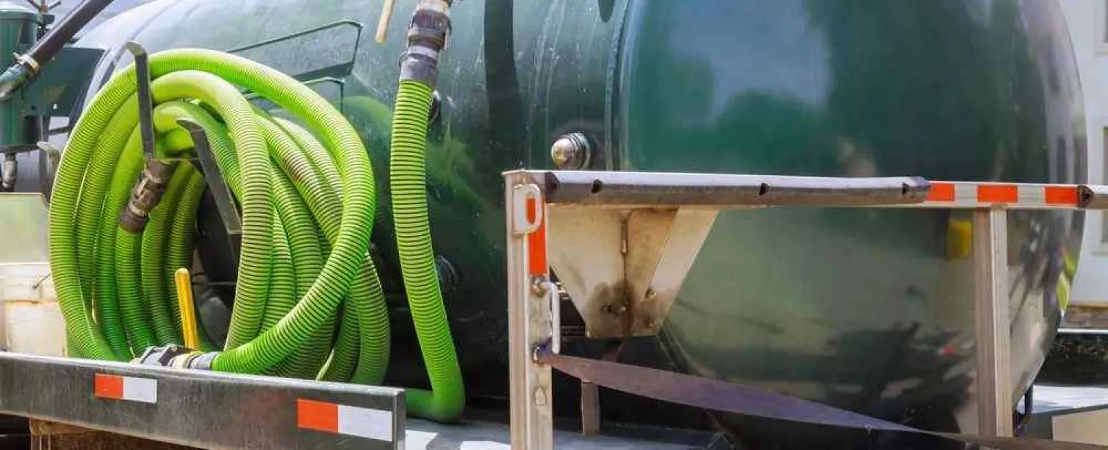 a green vehicle with a green hose