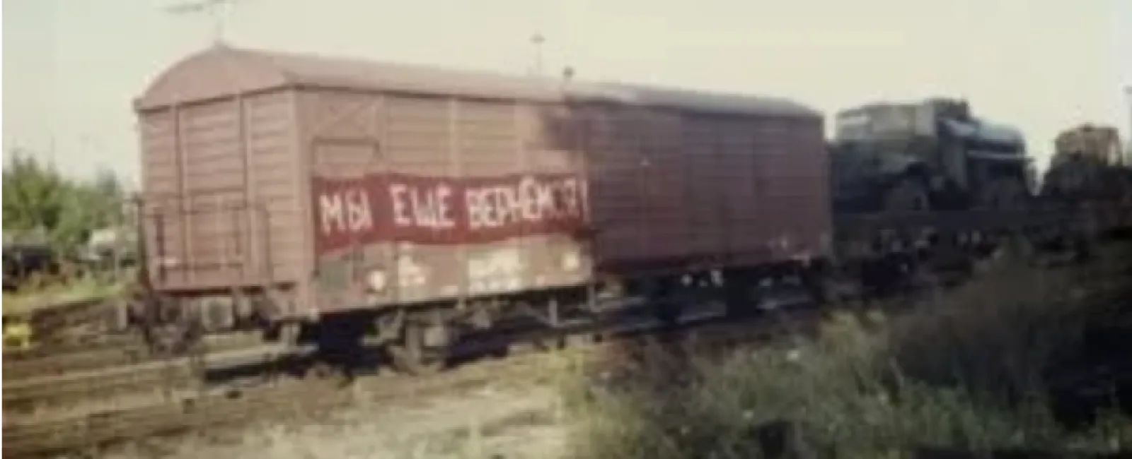 Banner on the last Russian military train leaving East Germany in the 90s reads: “We will be back”