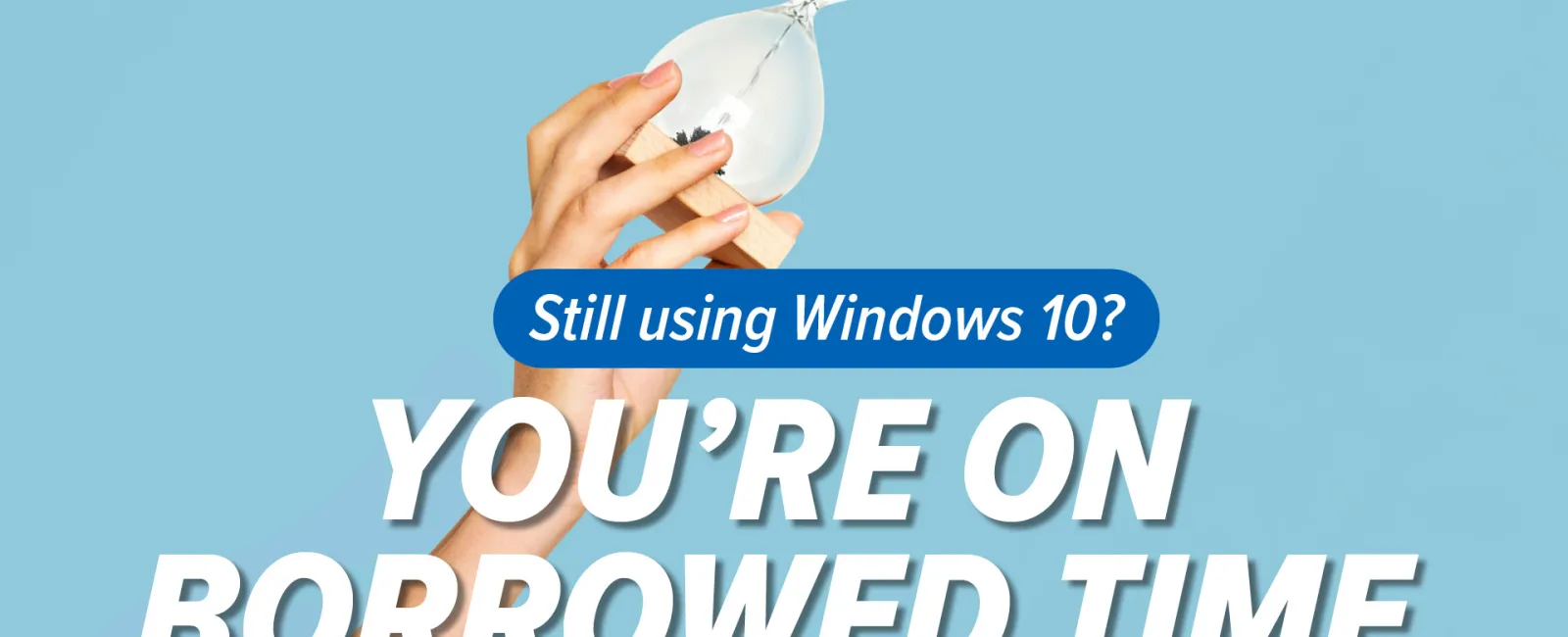 Hand holding hourglass with sand running out and text warning Windows 10 users they're on borrowed time