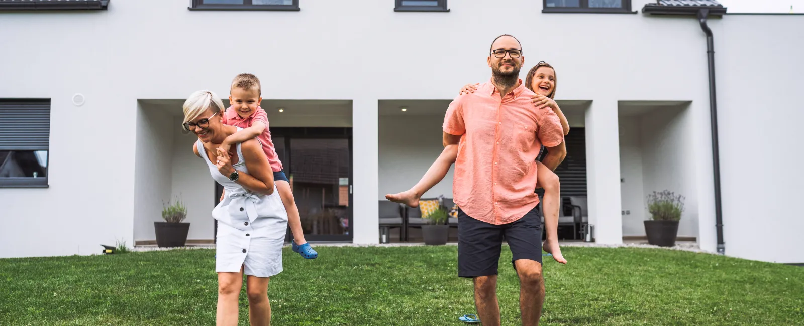 a person and two children standing in front of a house