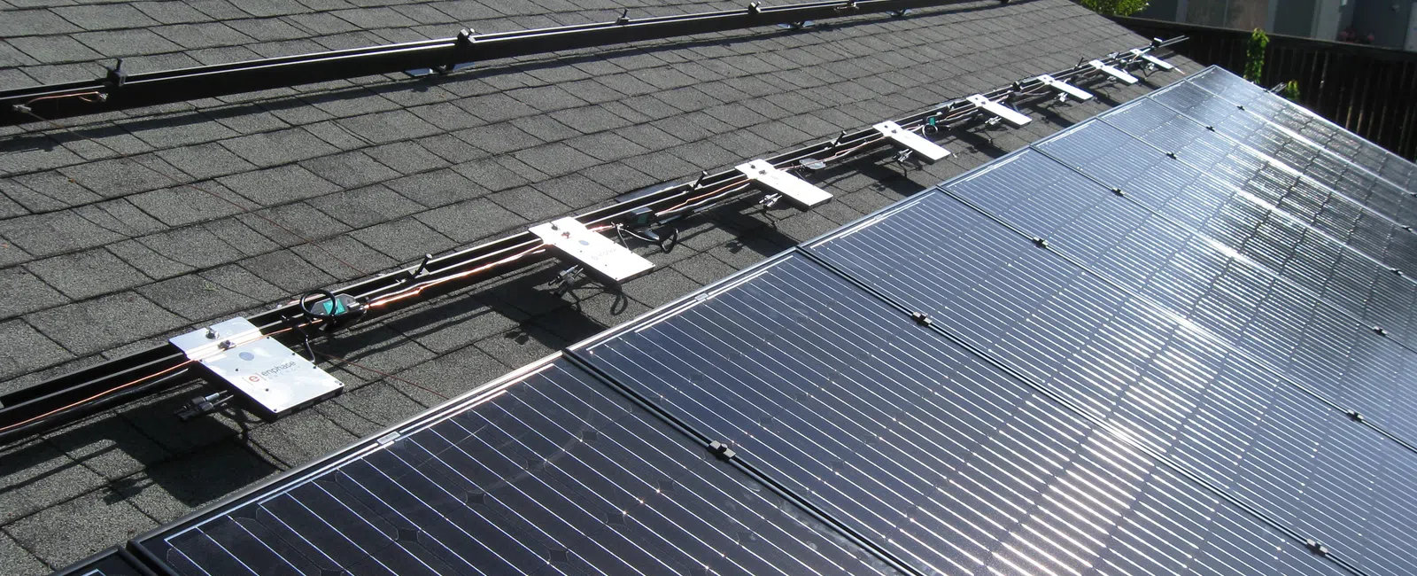 Residential rooftop solar panels installed on an asphalt shingle roof with Enphase microinverters