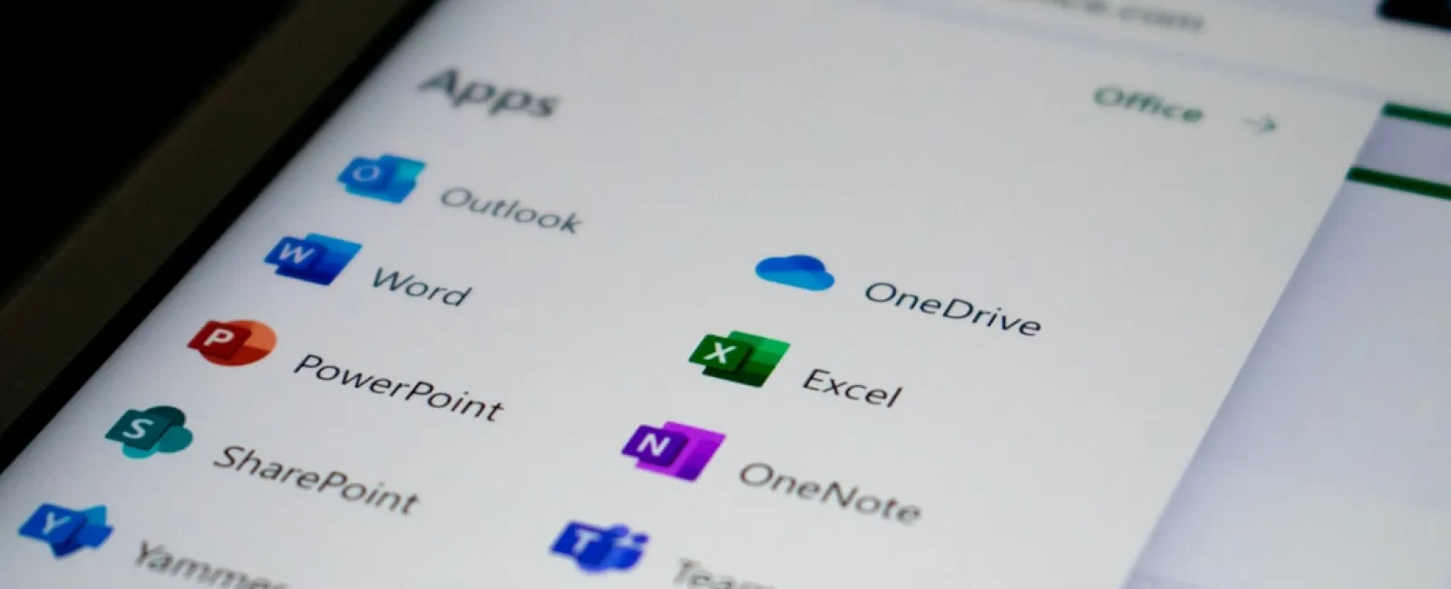 Screen showing Microsoft Office apps including Outlook, Word, Excel, PowerPoint, OneDrive, and Teams icons.