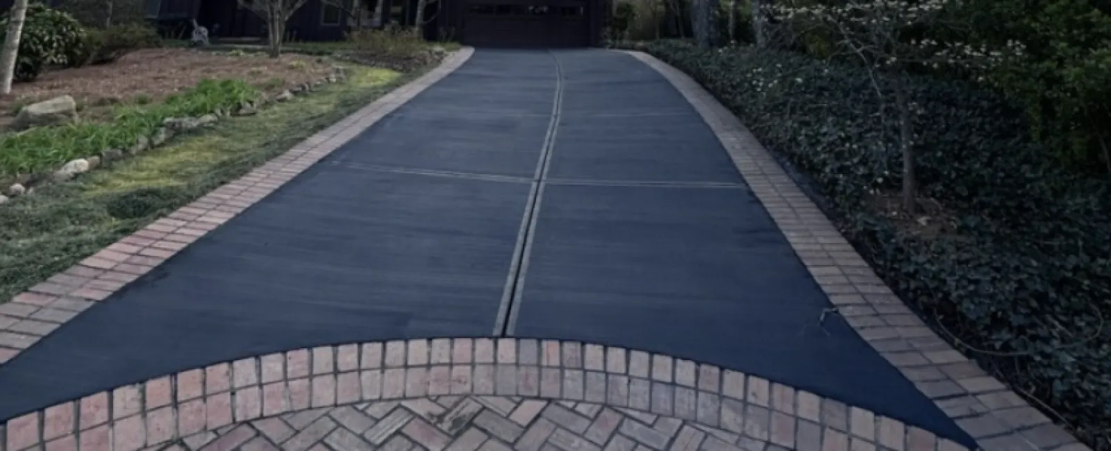 a paved road with trees on either side of it