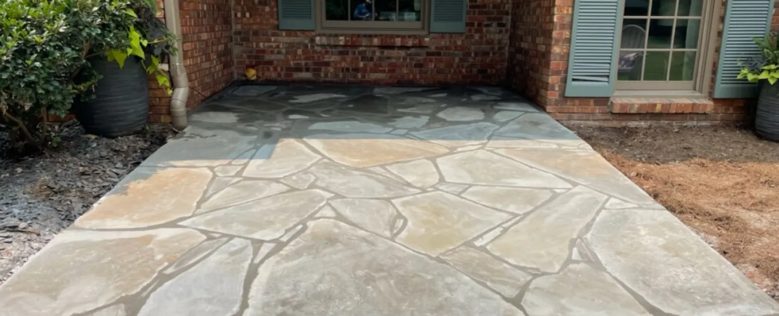 a stone walkway in front of a brick building