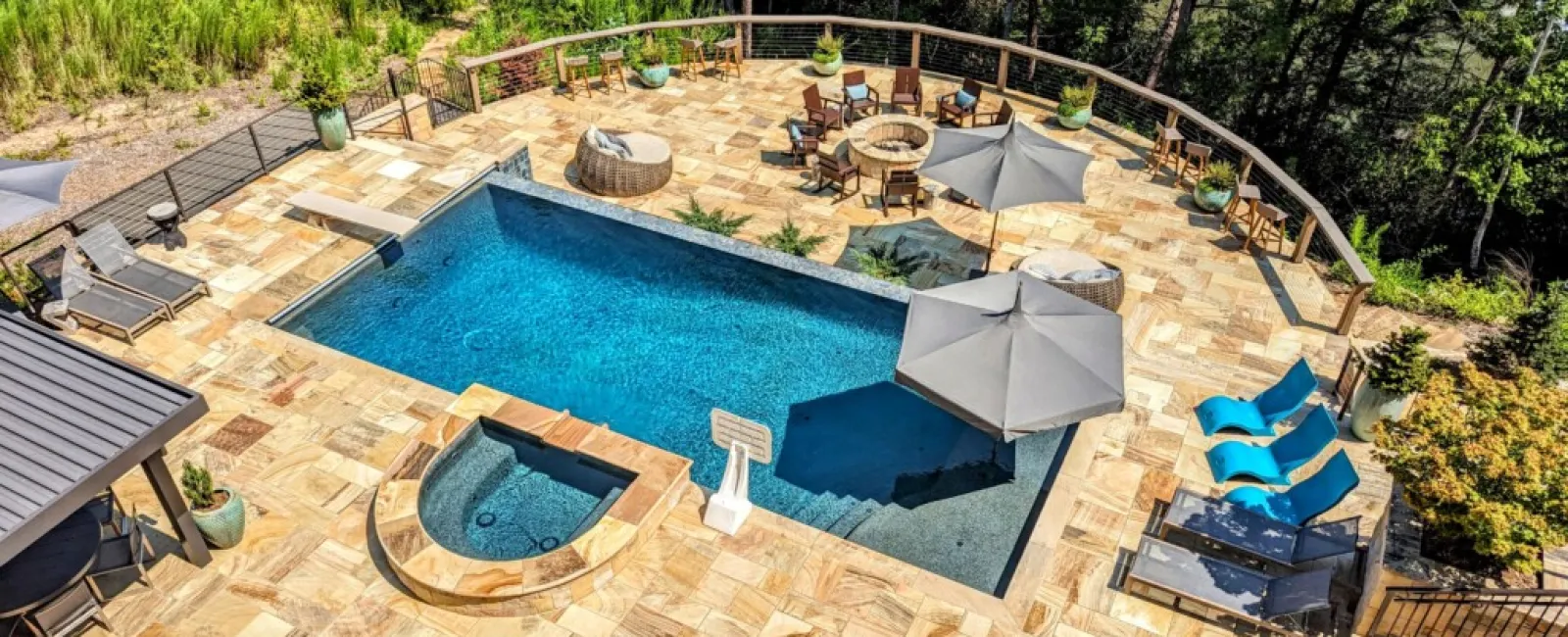 a pool with a deck and chairs