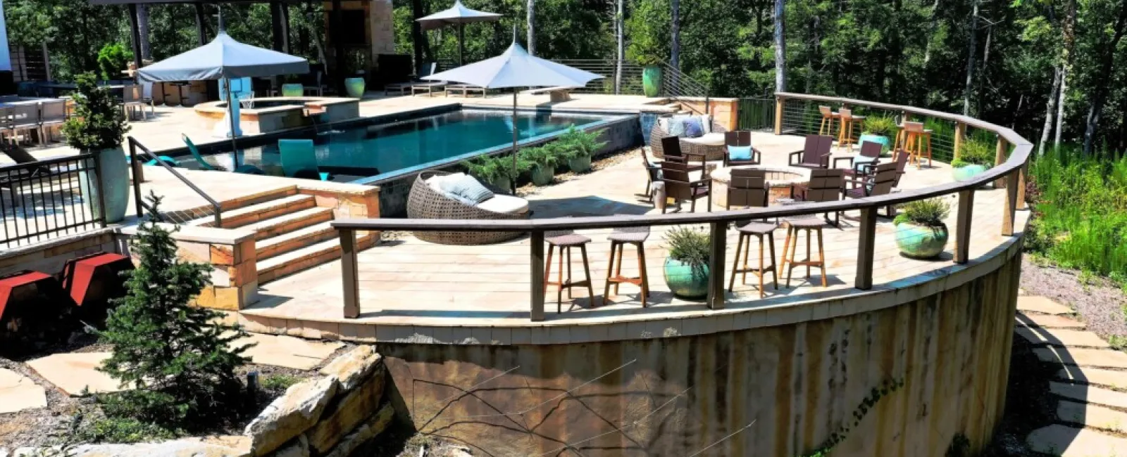 a pool with chairs and tables next to it