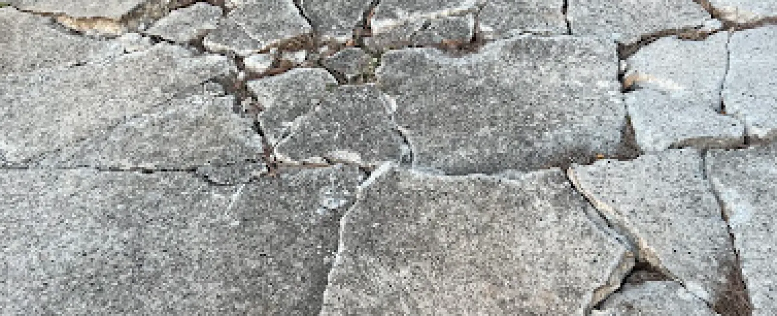 a cobblestone road with cracks