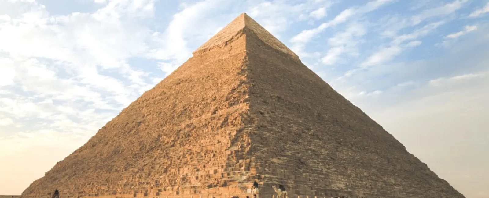 a pyramid with people on horses