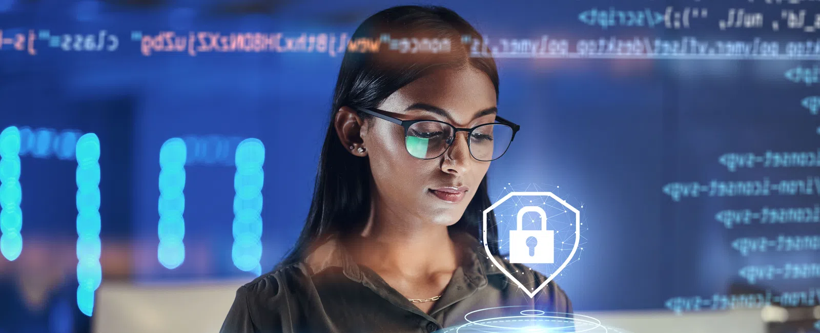 Woman with glasses using tablet displaying digital security lock icon and coding background representing cybersecurity.