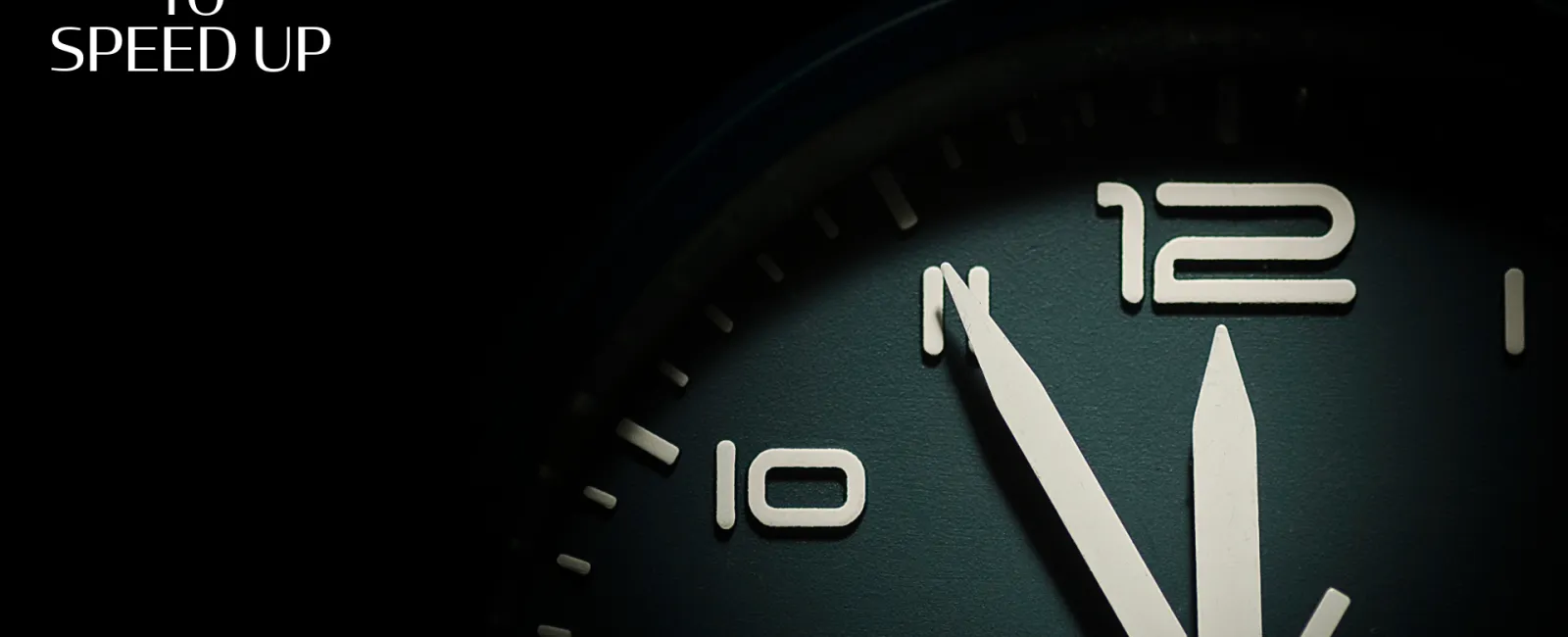 Close-up of a clock face showing the time 12:55 with the text Slow Down to Speed Up in white.