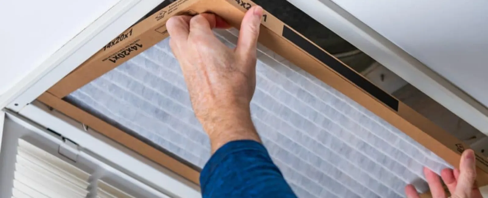 a person replacing their air filter