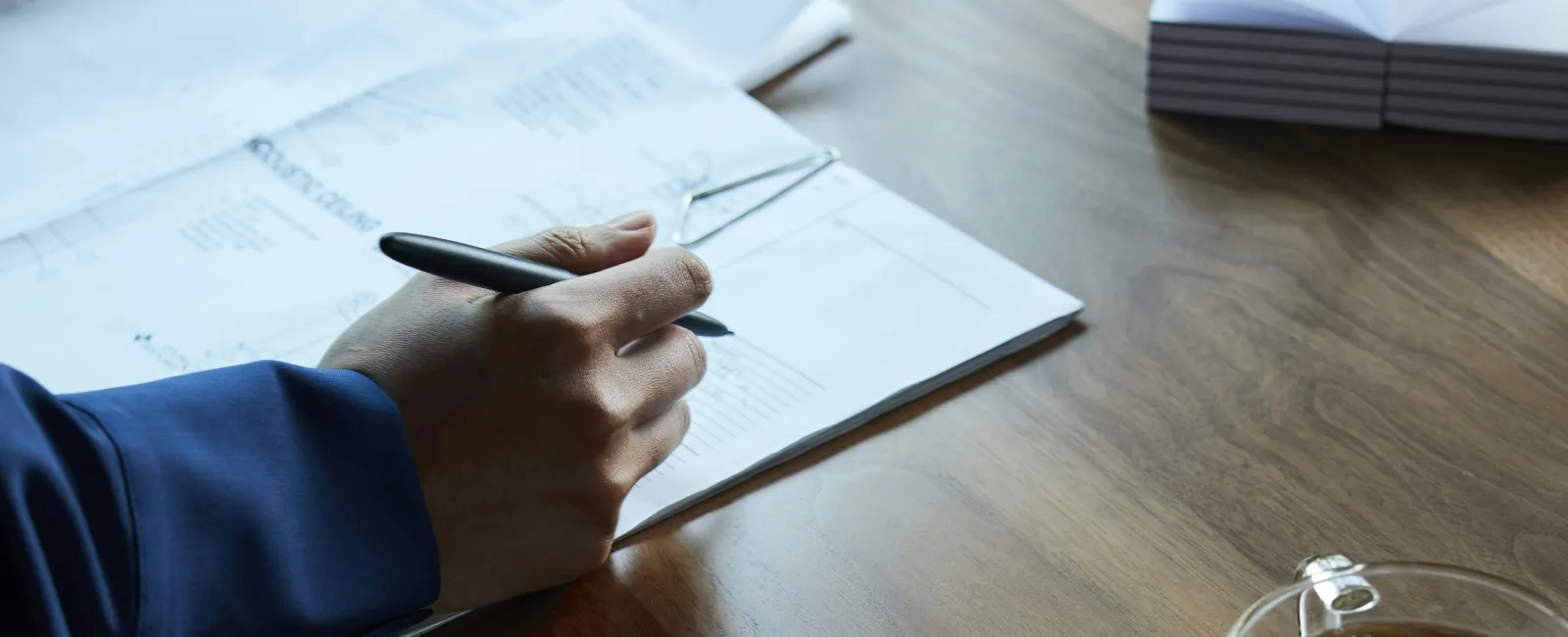 a person writing on a piece of paper