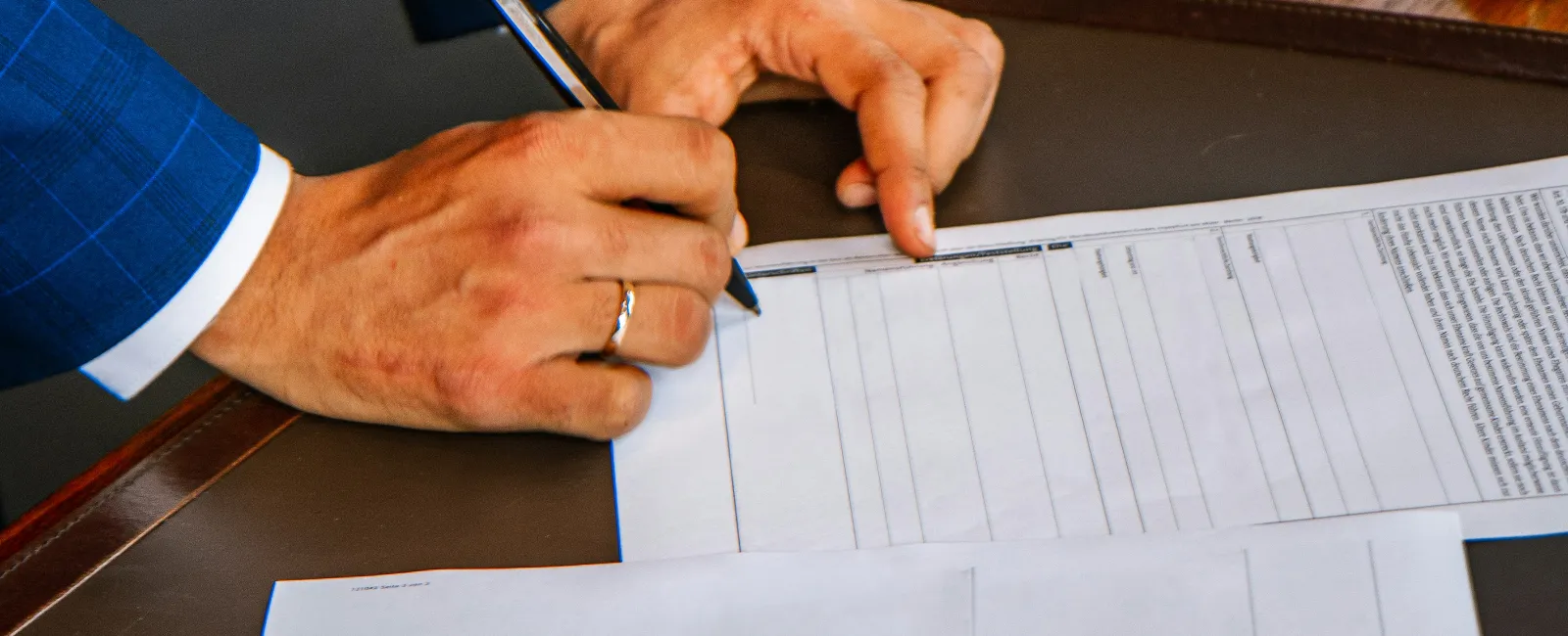 a person writing on a piece of paper