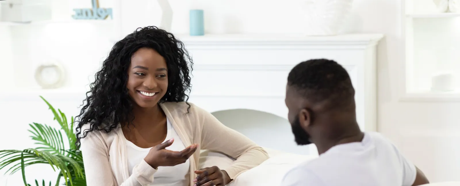 a man and a woman sitting on a couch taking