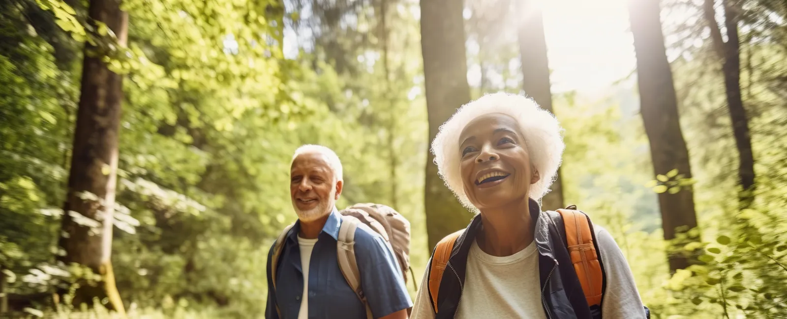 a man and woman walking in the woods