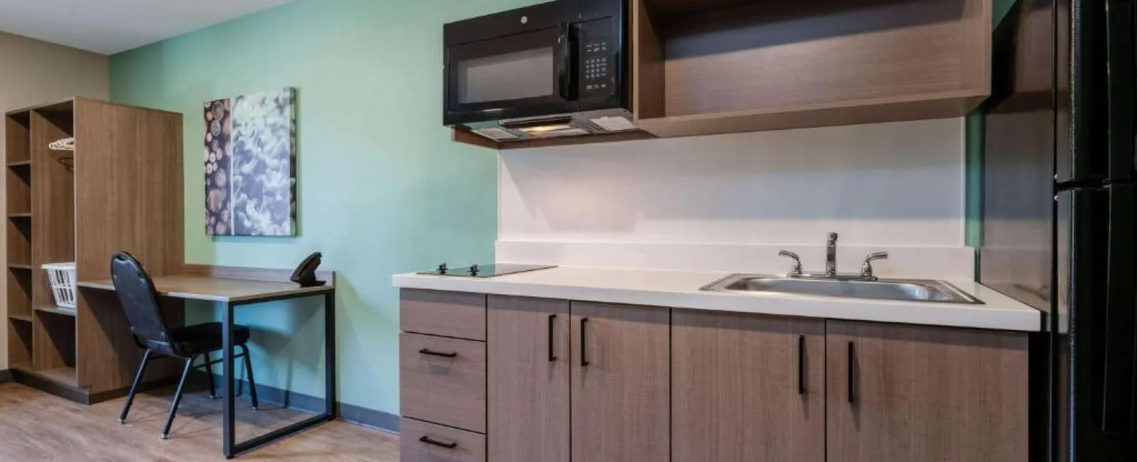 a kitchen with a microwave oven and cabinets