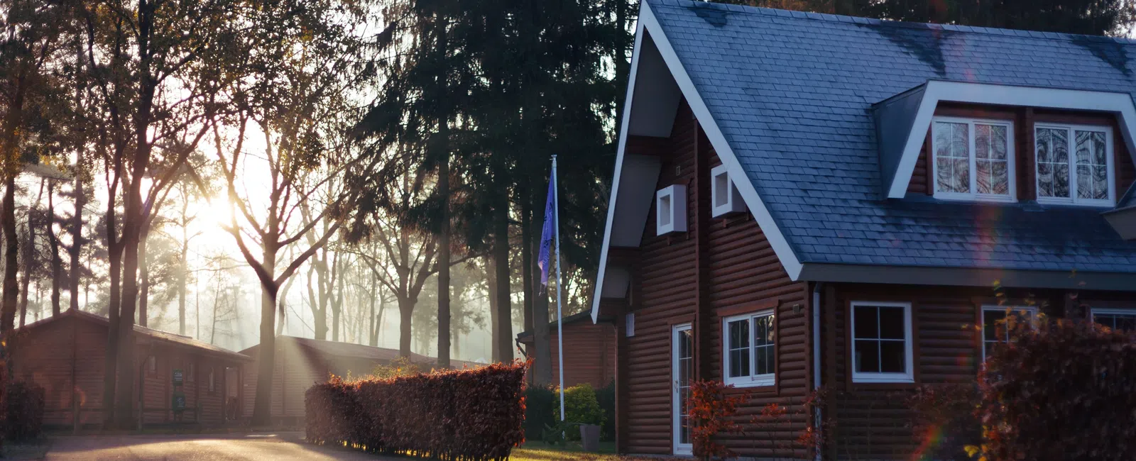 a house that has a sign on the side of a road