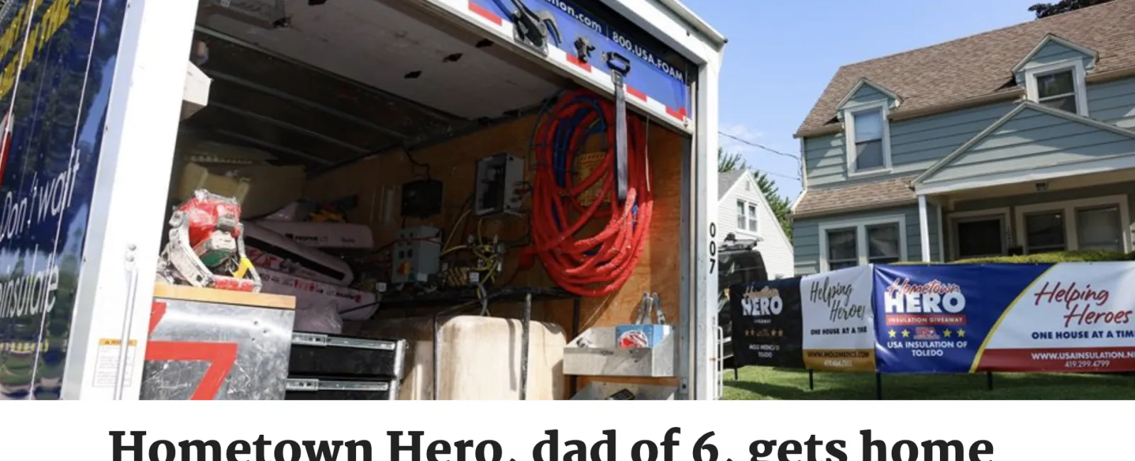 Open insulation service truck with equipment in front of a suburban home displaying Helping Heroes banners