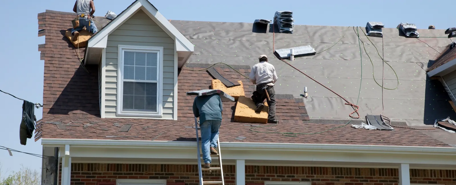 a group of men on top of a house