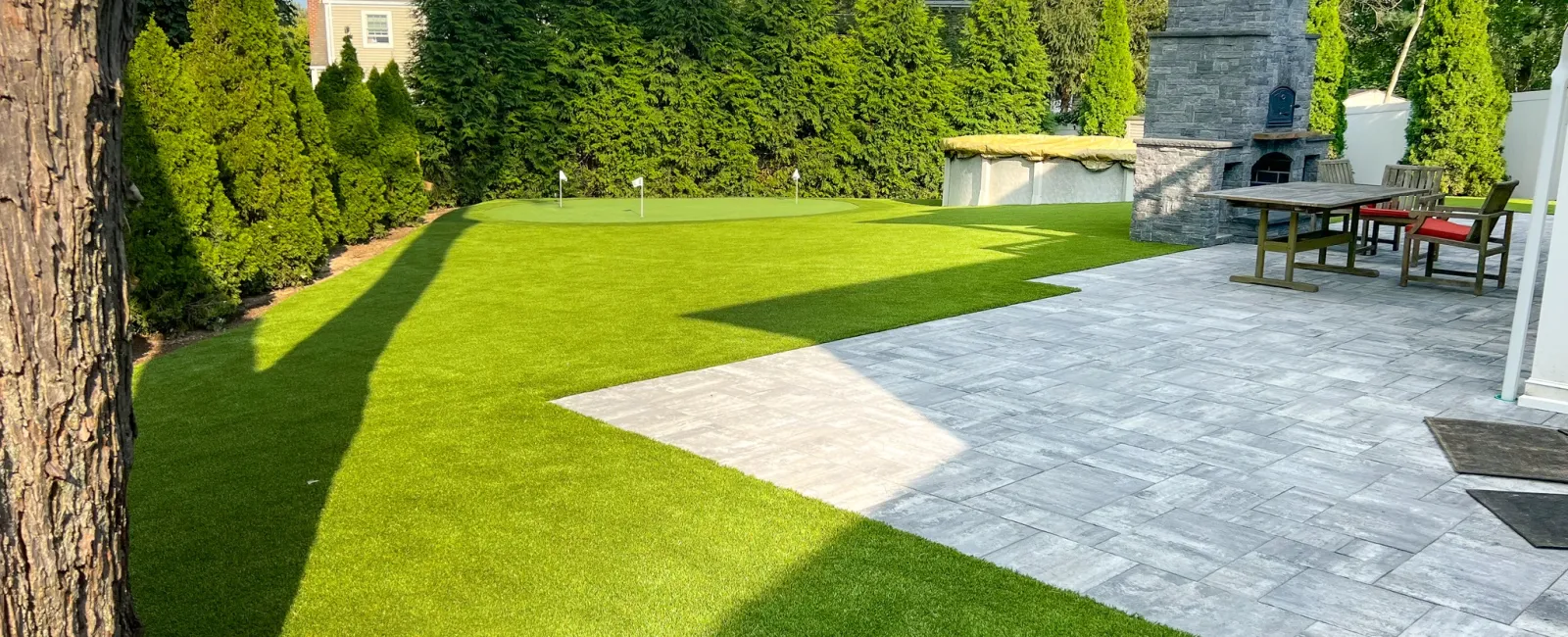 a backyard with a stone patio