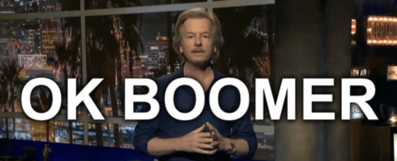 Comedian standing in a studio with text OK BOOMER overlaid, CTV Comedy Channel logo visible.